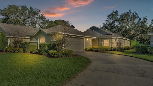 single story home with a yard and a garage