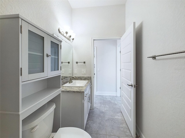 bathroom featuring tile patterned floors, vanity, and toilet