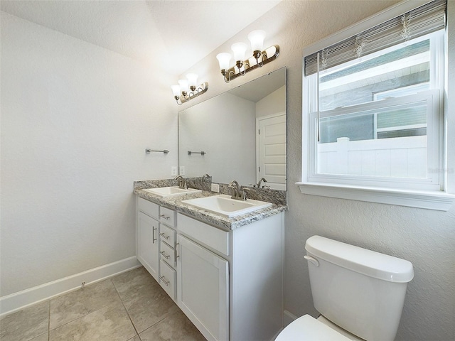 bathroom with tile patterned flooring, vanity, vaulted ceiling, and toilet