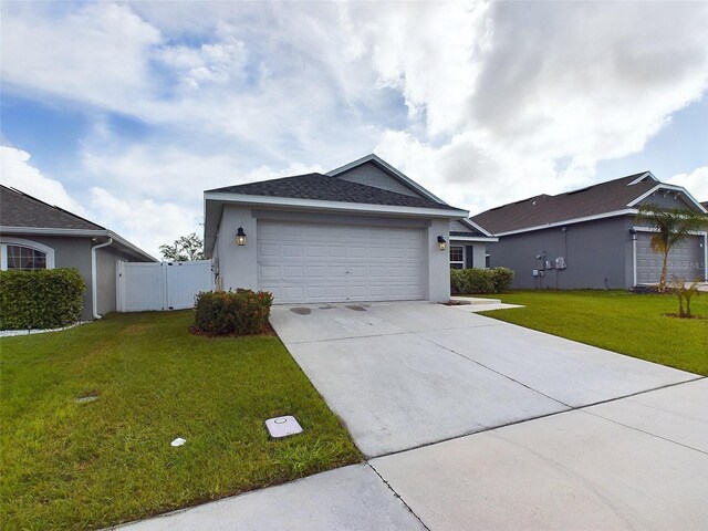 ranch-style home with a garage and a front lawn