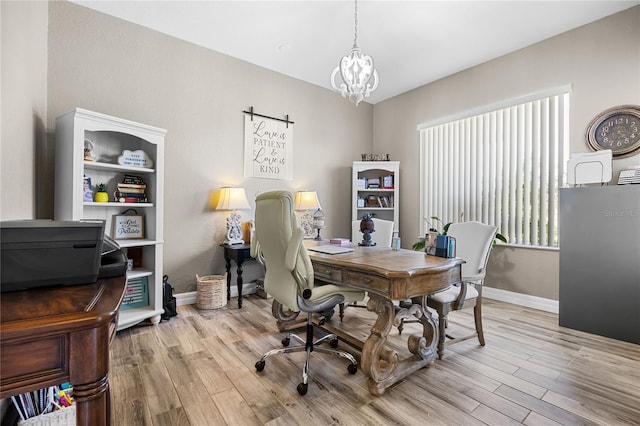 home office with a chandelier and light wood-type flooring