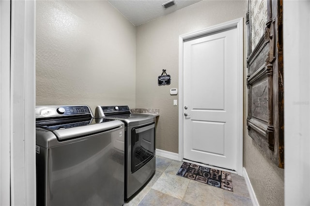 laundry area with washing machine and dryer