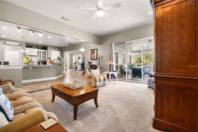 carpeted living room with ceiling fan