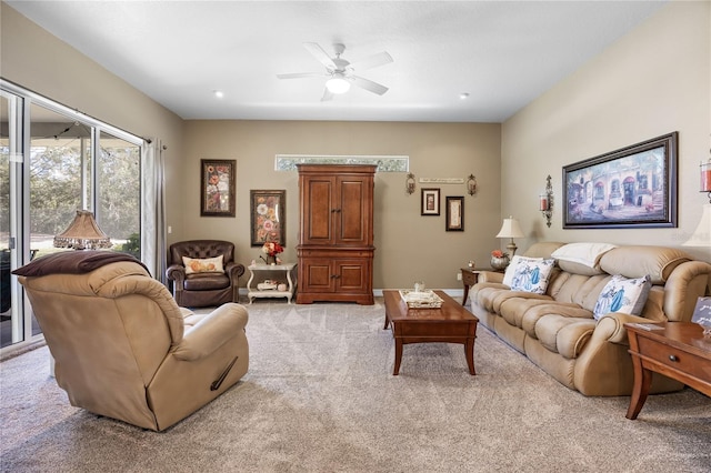 carpeted living room with ceiling fan