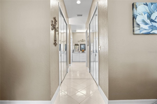 corridor featuring light tile patterned floors