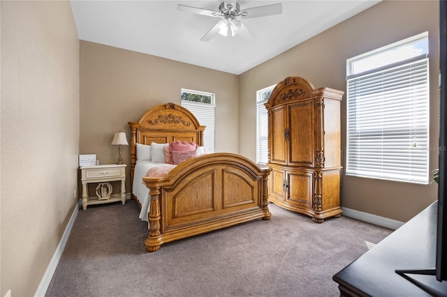 carpeted bedroom featuring ceiling fan and multiple windows