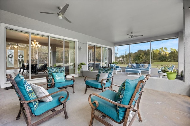 sunroom / solarium featuring ceiling fan with notable chandelier