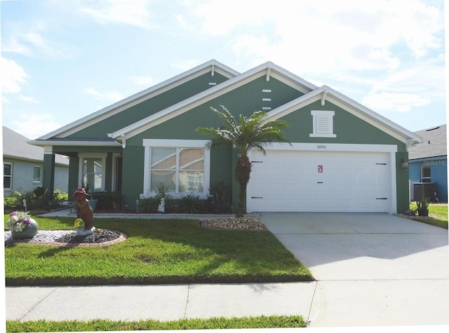 view of front of house with a garage and a front lawn