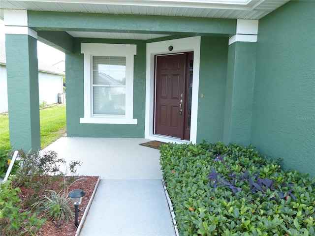 view of exterior entry with covered porch