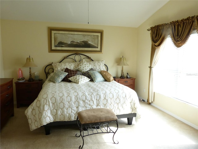 carpeted bedroom with lofted ceiling