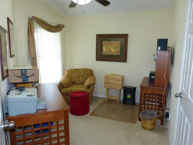 living area featuring carpet and ceiling fan