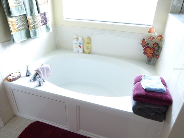 bathroom featuring tile patterned flooring and a washtub