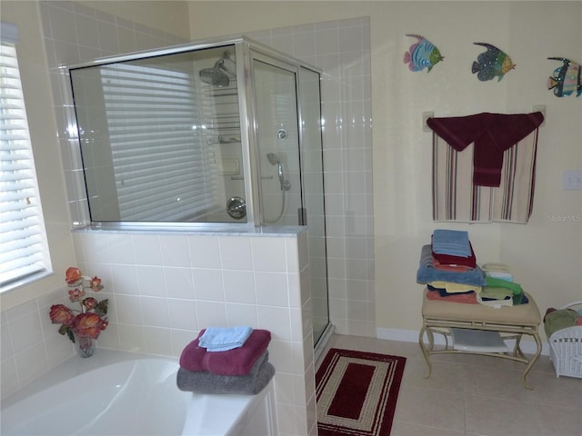 bathroom featuring tile patterned flooring and separate shower and tub