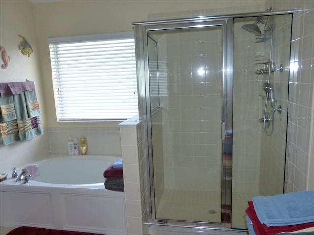 bathroom with shower with separate bathtub