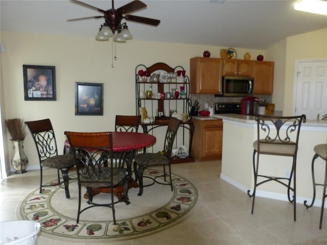 dining space with ceiling fan and light tile patterned floors