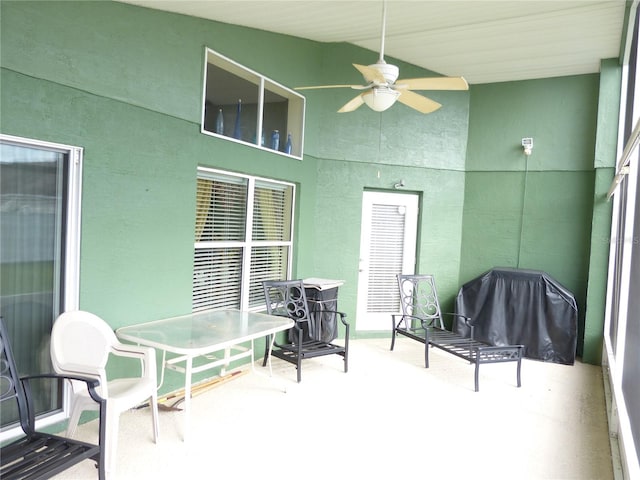 view of patio with area for grilling and ceiling fan