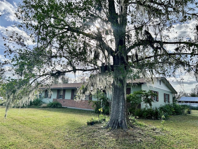 view of side of home with a yard