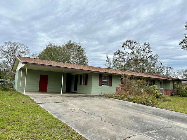 ranch-style house with a carport and a front lawn