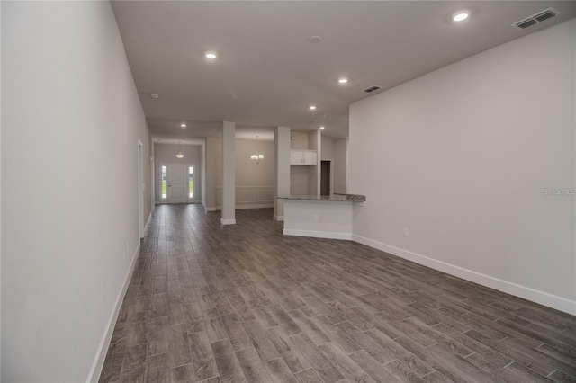 unfurnished living room with dark hardwood / wood-style floors