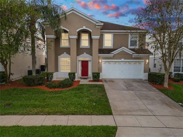 view of front of property featuring a yard and a garage