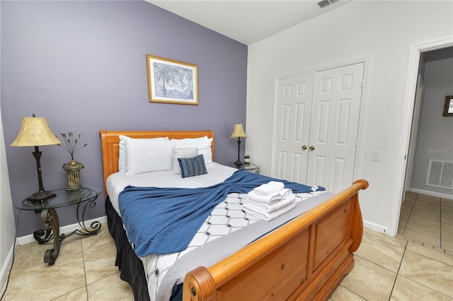 bedroom featuring light tile patterned flooring and a closet