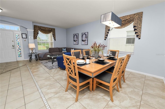 dining space featuring light tile patterned floors