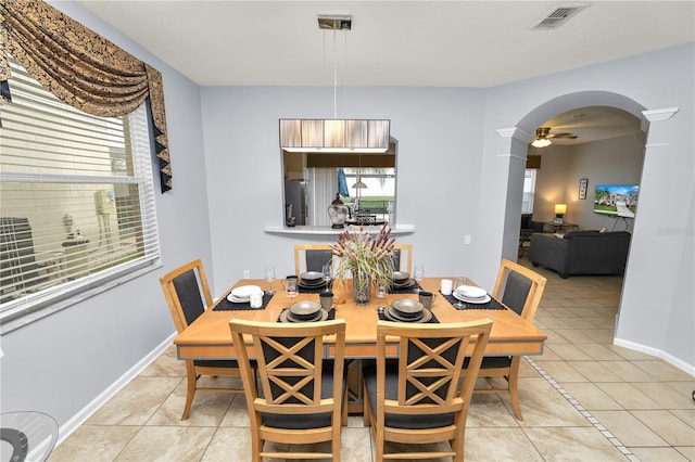 tiled dining area featuring ceiling fan