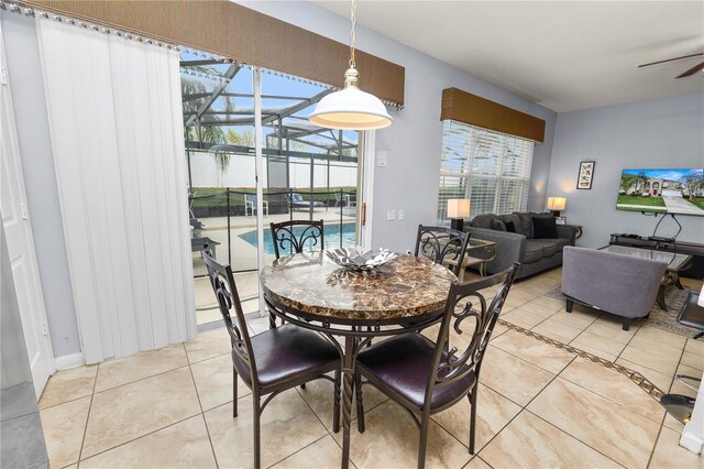 dining space featuring ceiling fan and light tile patterned floors