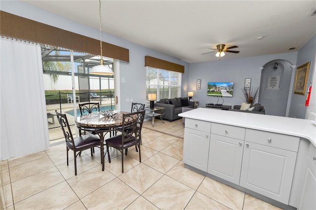 kitchen featuring decorative light fixtures, white cabinetry, ceiling fan, and light tile patterned flooring