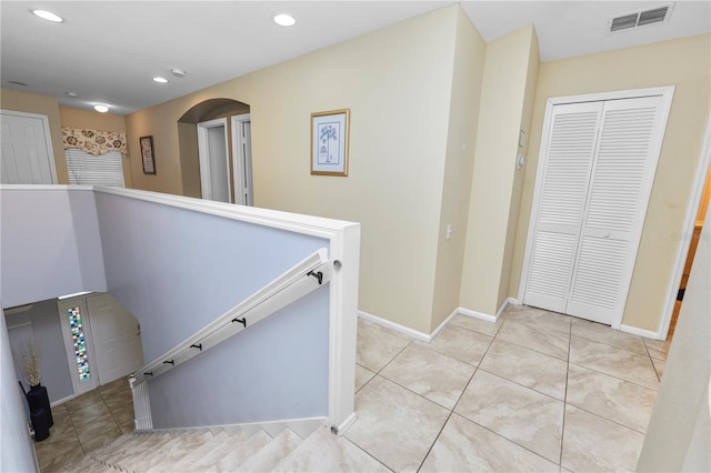 corridor featuring light tile patterned floors