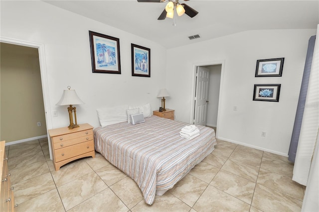 tiled bedroom with ceiling fan and vaulted ceiling