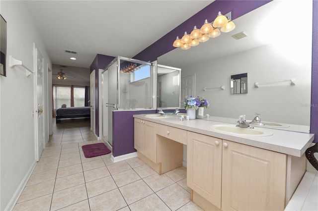 bathroom with tile patterned floors, ceiling fan, vanity, and walk in shower