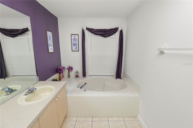 bathroom with tile patterned flooring, vanity, and tiled tub