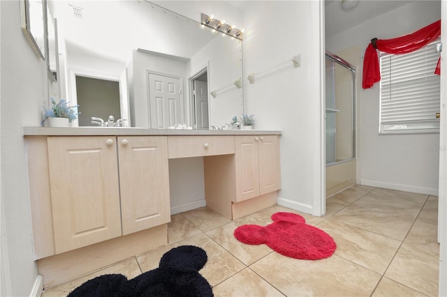 bathroom featuring combined bath / shower with glass door, vanity, and tile patterned flooring