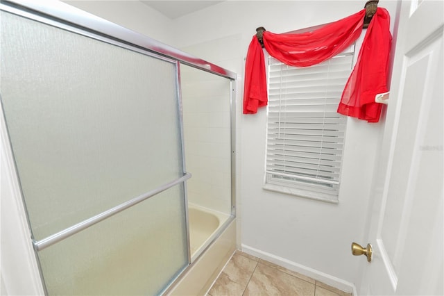 bathroom featuring tile patterned floors and combined bath / shower with glass door