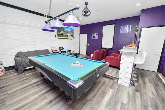 recreation room featuring dark wood-type flooring, brick wall, and pool table