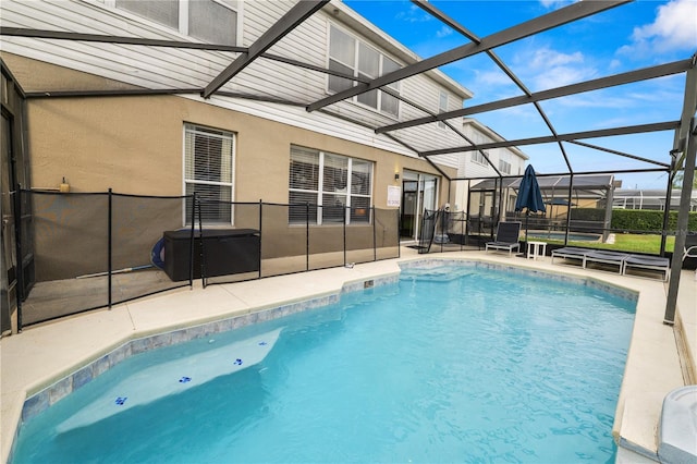 view of swimming pool with a lanai and a patio