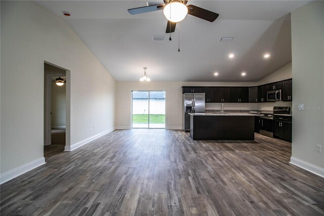 kitchen with stainless steel appliances, light countertops, visible vents, open floor plan, and a kitchen island with sink