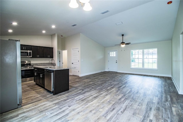 kitchen featuring visible vents, appliances with stainless steel finishes, a sink, and wood finished floors