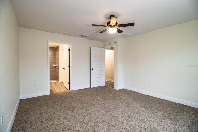 unfurnished bedroom with connected bathroom, a ceiling fan, visible vents, baseboards, and carpet