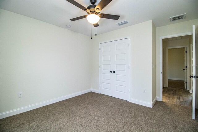 unfurnished bedroom featuring carpet floors, visible vents, and baseboards