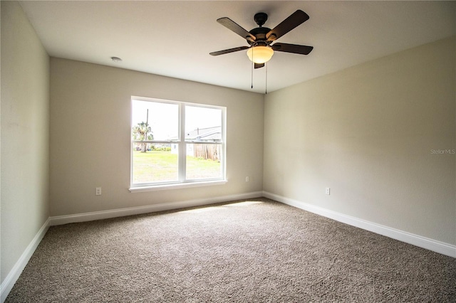 unfurnished room featuring a ceiling fan, carpet flooring, and baseboards