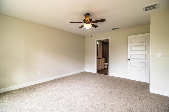 interior space with baseboards, visible vents, and dark carpet