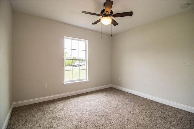 empty room with carpet floors, baseboards, and a ceiling fan