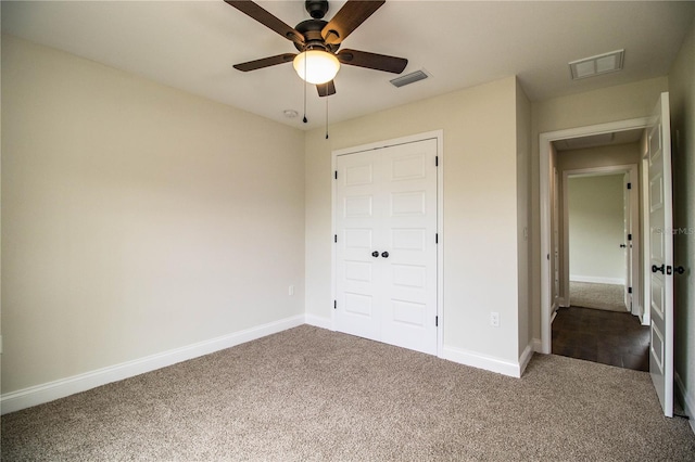 unfurnished bedroom featuring carpet floors, visible vents, baseboards, and a ceiling fan