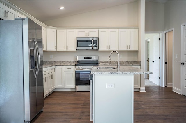 kitchen featuring lofted ceiling, dark wood-style floors, appliances with stainless steel finishes, white cabinetry, and a sink