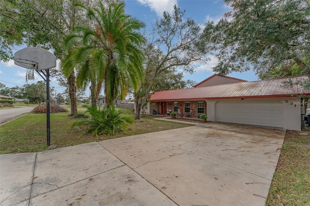 ranch-style home with a garage and a front lawn