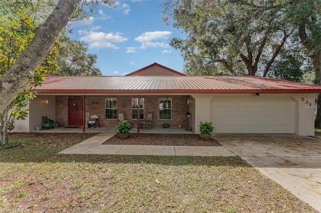 single story home with covered porch and a garage