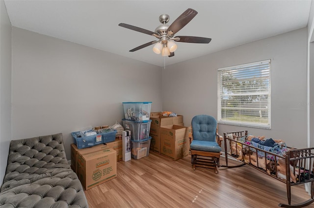 living area featuring ceiling fan and light wood-type flooring