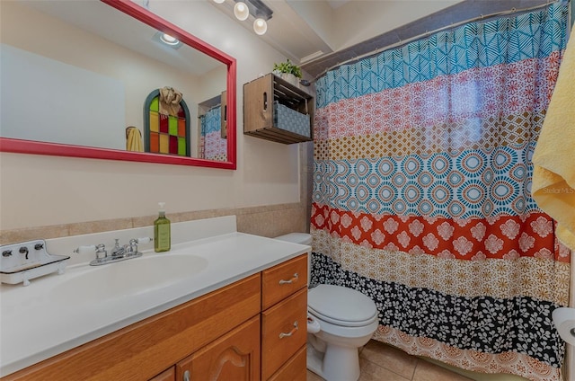 bathroom featuring tile patterned flooring, vanity, and toilet